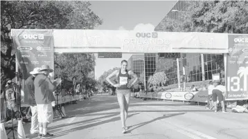  ?? COURTESY PHOTO ?? Sarah Sellers crosses the finish line after finishing 2nd in the 2015 OUC Half Marathon, shortly after completing an overnight hospital shift. - Original Credit: Courtesy Track Shack - Original Source: Courtesy Track Shack