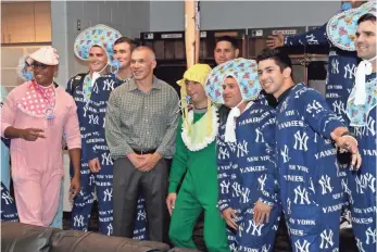  ?? CHRIS O’MEARA, AP ?? Manager Joe Girardi, center, accompanie­s Yankees rookies dressed as babies.