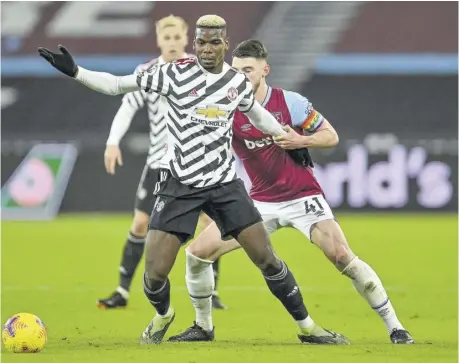  ?? (Photo: AFP) ?? West Ham United’s English midfielder Declan Rice (right) vies with Manchester United’s French midfielder Paul Pogba during the English Premier League football match at The London Stadium, in east London, on Saturday.