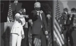  ?? ANDREW HARNIK/ASSOCIATED PRESS ?? President-elect Joe Biden and Vice President-elect Kamala Harris stand on the stage Nov. 7 in Wilmington, Del.