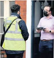  ?? Julian Hamilton ?? ● Resident Ollie Cowan receives a Covid test kit from one the door to door mass testing staff, in Southport, Merseyside, as neighbours in the PR9 postcode area try to combat the spread of the new
South African Covid variant