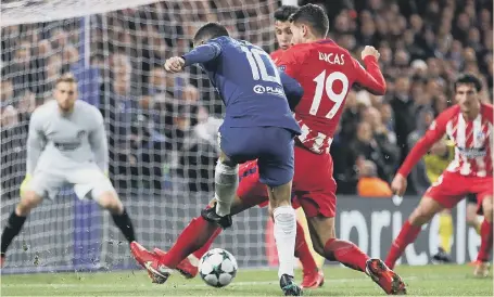  ??  ?? Eden Hazard slams home Chelsea’s goal in last night’s 1-1 Champions League draw with Atletico Madrid at Stamford Bridge.