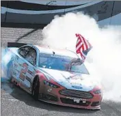  ?? Robert Laberge Getty Images ?? BRAD KESELOWSKI celebrates after winning the NASCAR Sprint Cup Series race at Fontana.