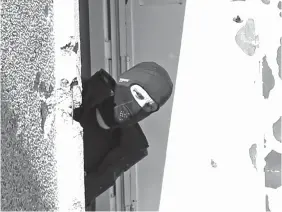  ?? ASSOCIATED PRESS ?? A masked police officer searches for clues at terrorist Mohamed Merah’s apartment building in Toulouse, southweste­rn France.