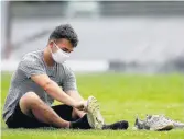  ?? KAITLIN MCKEOWN/STAFF FILE ?? Green Run’s Caden Unruh puts on cleats prior to a workout on July 13 in Virginia Beach.