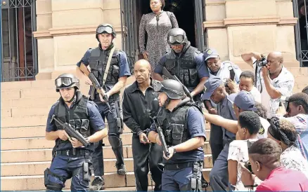  ??  ?? Mduduzi Mabaso, handcuffed, plays the role of the late heist kingpin Collen Chauke in the film ‘State Enemy no.1’.