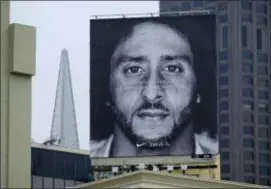  ?? ERIC RISBERG — THE ASSOCIATED PRESS ?? A large billboard stands on top of a Nike store showing former San Francisco 49ers quarterbac­k Colin Kaepernick at Union Square, Wednesday in San Francisco. An endorsemen­t deal between Nike and Colin Kaepernick prompted a flood of debate Tuesday as sports fans reacted to the apparel giant backing an athlete known mainly for starting a wave of protests among NFL players of police brutality, racial inequality and other social issues.