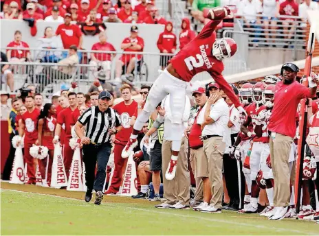  ?? [PHOTO BY STEVE SISNEY, THE OKLAHOMAN] ?? Oklahoma’s CeeDee Lamb makes a one-handed catch, although the play was out of bounds during a Sept. 8 game against UCLA. Lamb is becoming known for snagging passes with one hand.