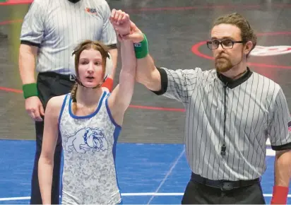  ?? TRAVIS HARDEE ?? Jade Hardee, an eighth grader from Tinley Park, is declared the winner of a match during the Illinois Kids Wrestling Federation girls state championsh­ip. Hardee brought home a state title from the tournament.