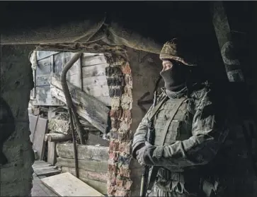  ?? Brendan Hoffman Getty Images ?? A UKRAINIAN soldier takes up a front-line position in the Donetsk region. Russia’s military buildup along its border with Ukraine has led the U.S. and allies to warn that any invasion will be met with stiff sanctions.