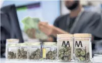  ?? JOHN LOCHER THE ASSOCIATED PRESS FILE PHOTO ?? Private cannabis stores will have to give up offering delivery and curbside pickup, which helped generate more business during the pandemic, despite a likely extension of emergency orders