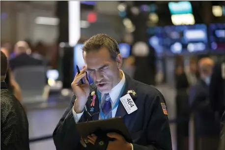  ?? MARK LENNIHAN — THE ASSOCIATED PRESS FILE ?? In this file photo Stock trader Gregory Rowe works at the New York Stock Exchange.