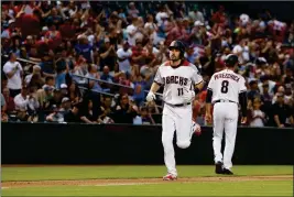  ?? ASSOCIATED PRESS ?? ARIZONA DIAMONDBAC­KS’ A.J. POLLOCK (11) rounds the bases after celebratin­g his home run against the Los Angeles Dodgers with third base coach Tony Perezchica (8) during the second inning of a baseball game Monday in Phoenix.