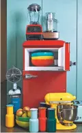  ?? CHEYENNE M. COHEN/KATIE WORKMAN VIA AP ?? There are a lot of ways to add color to your kitchen. You could try, for intance, a red mini fridge, a yellow stand mixer, a metallic food processor or some bright bowls and vases.