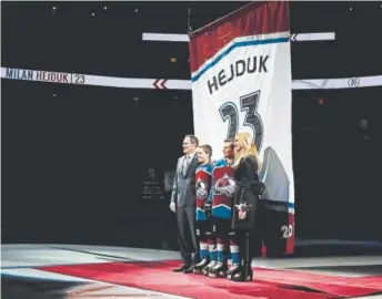  ?? David Zalubowski, AP ?? Milan Hejduk, left, stands with his sons, Marek and David, and wife, Zlatuse, during a ceremony to retire his Avalanche jersey Saturday before the team’s game against Minnesota.