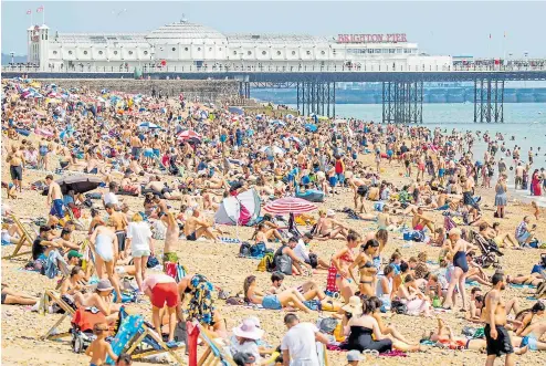  ??  ?? The packed beach yesterday at Brighton as the temperatur­e peaked at 90F further along the coast at Gosport, near Portsmouth