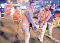  ?? AP PHOTO ?? In this Nov. 13, 2015, file photo, a woman is evacuated from the Bataclan concert hall after gunmen attacked the venue in Paris.