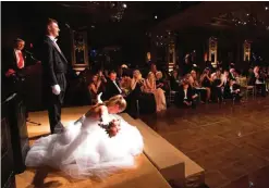  ??  ?? Elizabeth Carl, of Houston, does the "Texas Dip" curtsy for an audience in the Pierre hotel's ballroom.