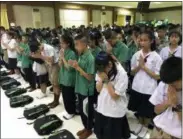  ?? JOHNSON LAI — THE ASSOCIATED PRESS ?? Students pray at Maesaipras­itsart school where six out of the rescued 12 boys study as they cheer the successful rescue in the Mae Sai district in Chiang Rai province, northern Thailand, Wednesday.