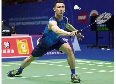  ?? — AFP ?? Focused: Lee Zii Jia returning a shot to India’s Sameer Verma during the men’s singles match of the Sudirman Cup in Nanning, China, yesterday.