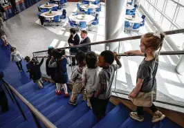  ?? JIM NOELKER PHOTOS / STAFF ?? Students at the Greater Dayton School head to the gymnasium for the school’s grand opening and ribbon-cutting on Tuesday.