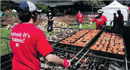  ?? NICK PROCAYLO/PNG FILES ?? A salmon barbecue pit during Canada Day celebratio­ns in Steveston, B.C.