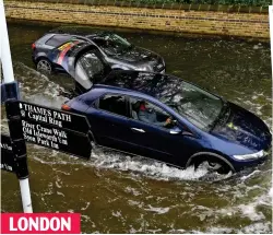  ??  ?? Cars struggle to make progress on a road by the Thames