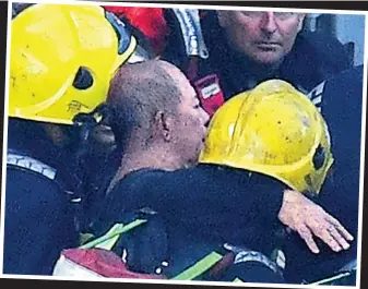  ??  ?? Relief: The Grenfell resident is carried out of the tower block