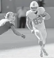  ?? JOHN MCCALL/SUN SENTINEL ?? Dolphins tight end Nick O’Leary gains a few yards against the Lions on Oct. 21 at Hard Rock Stadium in Miami Gardens.