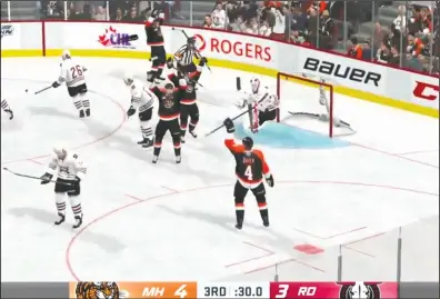  ??  ?? SCREENSHOT FROM TWITCH.TV/DJORANGEMA­N
The Medicine Hat Tigers celebrate what turns out to be a game-winning goal on Brandon McGraw’s livestream of NHL20 Tuesday night.