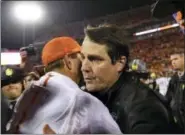  ?? RICHARD SHIRO - THE ASSOCIATED PRESS ?? FILE - In this Nov. 26, 2016, file photo, Clemson head coach Dabo Swinney, left, and South Carolina head coach Will Muschamp meet at midfield after an NCAA college football game against in Clemson, S.C. Clemson won 56-7. South Carolina’s mission is as...