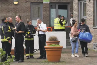  ?? Justin Tallis / AFP / Getty Images ?? Residents with belongings (right) leave a residentia­l block on the Chalcots Estate in north London. Occupants of at least 650 London apartments were evacuated amid fire safety fears.