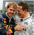  ?? Foto: Jens Bütnner, dpa ?? Freunde: Sebastian Vettel und Michael Schumacher.