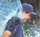  ?? STACY REVERE/GETTY IMAGES ?? Brewers starting pitcher Robert Gasser gets doused with Gatorade following the victory over the Cardinals on Friday night at American Family Field. Gasser tossed six shutout innings, allowing just two hits with no walks and four strikeouts in his major-league debut.