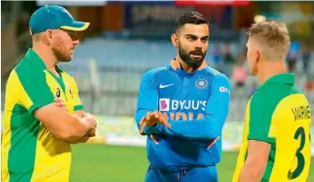  ??  ?? Australia’s one-day internatio­nal captain Aaron Finch (left) and David Warner (right) listen as Indian captain Virat Kohli speaks during the recent series in Australia.