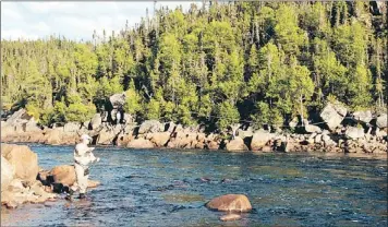  ?? — Photo by Paul Smith/special to The Telegram ?? Low water, but the boys keep fishing.