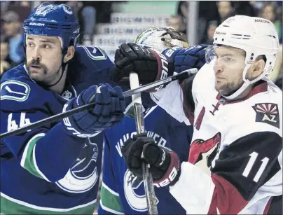  ?? AP PHOTO ?? Vancouver Canucks defenceman Erik Gudbranson (left) tries to clear Arizona Coyotes centre Martin Hanzal from in front of the Canucks net during NHL action in Vancouver, B.C., in November 2016.