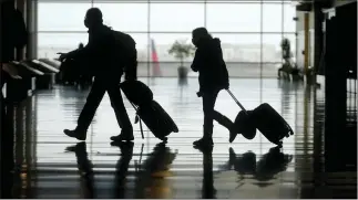  ?? RICK BOWMER — THE ASSOCIATED PRESS FILE ?? Travelers walk through the Salt Lake City Internatio­nal Airport, in Salt Lake City. The number of people flying in the United States has eclipsed the year-ago level for the first time in the pandemic period,