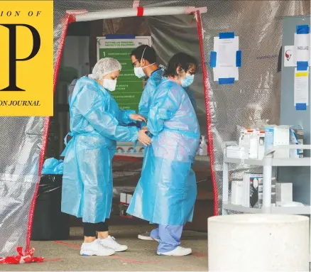  ?? RYAN REMIORZ / THE CANADIAN PRESS ?? Health-care workers put on their protective equipment before entering the Vigi Mount Royal long-term care residence in Montreal on Friday.