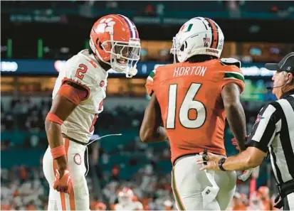  ?? LYNNE SLADKY/AP ?? Clemson cornerback Nate Wiggins, left, reacts after breaking up a pass intended for Miami wide receiver Isaiah Horton Oct. 21 in Miami Gardens, Florida.