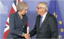  ?? AP ?? EUROPEAN Commission President Jean-Claude Juncker shakes hands with British Prime Minister Theresa May before their meeting at the European Commission headquarte­rs in Brussels, yesterday. |