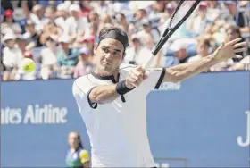  ?? Timothy A. Clary / Getty images ?? roger federer of Switzerlan­d dropped only five games in three sets against daniel evans of Great Britain during their third-round match friday at the u.s. open. federer had only 19 unforced errors in the match.