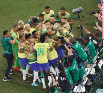  ?? (Reuters) ?? Brazil’s Casemiro (also right) celebrates with teammates after scoring against Switzerlan­d during the FIFA World Cup Qatar 2022 Group G match at the Stadium 974 in Doha yesterday.
