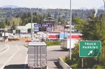  ?? ELAINE THOMPSON / THE ASSOCIATED PRESS FILES ?? Truck traffic moves into Canada from the U.S. in May, after a crackdown on non-essential travel to help prevent the spread of the coronaviru­s drasticall­y reduced the number of border crossings.