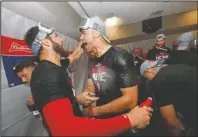  ?? The Associated Press ?? NLCS SURPRISE: St. Louis Cardinals starting pitcher Jack Flaherty, right, celebrates with teammate Daniel Ponce de Leon Wednesday after the Cardinals beat the Atlanta Braves 13-1 in Game 5 of the National League Division Series in Atlanta.