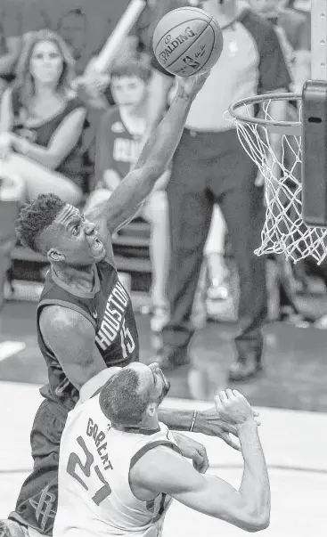  ?? Michael Ciaglo / Houston Chronicle ?? Rockets center Clint Capela soars to the basket over Jazz center Rudy Gobert to score two of his 16 points in Sunday’s 110-96 playoff win at Toyota Center. Capela also had 12 rebounds.