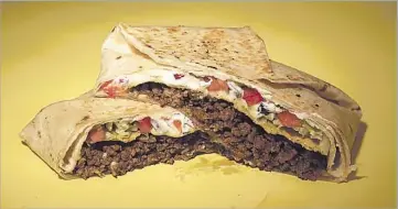  ?? Photograph­s by Kirk McKoy
Los Angeles Times ?? A CRUNCHWRAP
involves a f lour tortilla around taco meat, cheese sauce, lettuce, sour cream and a tostada.