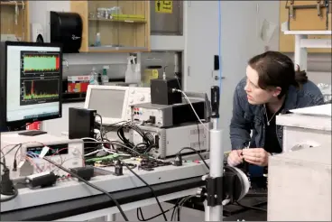  ?? HERALD PHOTO BY ALEJANDRA PULIDO-GUZMAN ?? U of L Gates Cambridge Scholar Alicia Anderson calibrates a new spectromet­er concept that is beind developed for a future farinfrare­d space mission Wednesday at a lab in the University of Lethbridge Science Commons.