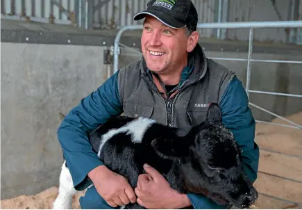  ??  ?? Federated Farmers Manawatu/ Rangitikei president James Stewart with a new season’s calf.