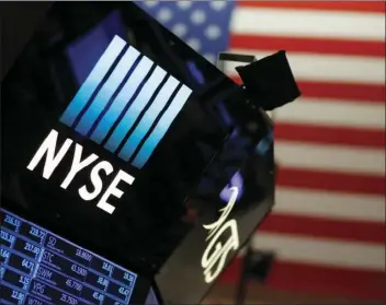  ??  ?? A logo for the New York Stock Exchange is displayed above the trading floor, Wednesday. Wall Street delivered big gains and shattered stock market records in 2017 as a global economic rebound, strong company earnings growth and the GOP-led push to...